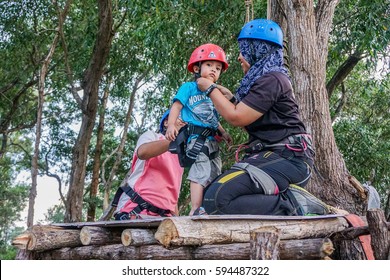 Labuan,Malaysia-Feb 12,2017:Happy Kid With Safety Harness Before Playing On A Flying Fox In Labuan,Malaysia.There Will Be More Ziplines In Malaysia,especially When There Have So Much Natural Resources