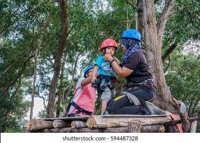 Labuan,Malaysia-Feb 12,2017:Happy Kid With Safety Harness Before Playing On A Flying Fox In Labuan,Malaysia.There Will Be More Ziplines In Malaysia,especially When There Have So Much Natural Resources