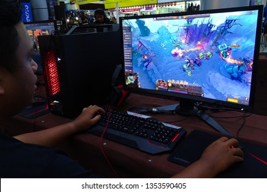 Labuan,Malaysia-March 29,2019:Young people playing video games Dota 2 in cyber cafe at Labuan,Malaysia.It is a multiplayer online battle arena video game developed & published by Valve Corporation.
