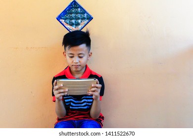 Labuan,Malaysia-May 30,2019:Boy Surfing Internet On Digital Smartphone In Labuan,Malaysia.Too Much Screen Time Can Lead To Irregular Sleep Patterns,behavioural Problems & A Lack Of Social Skills.