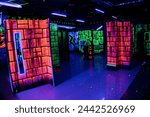 Labyrinth in neon light. Laser tag, paintball in a labyrinth with multi-colored lighting