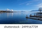 Lac Léman - Lake Geneva.
View on the lake in Lausanne with mountains in the back and small clouds.