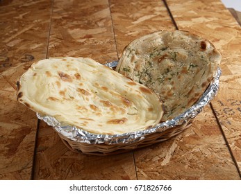 Lachha Paratha Naan Served In A Bamboo Basket On Wooden Background