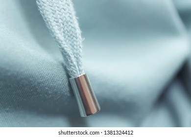 Lacing Tie On The Jacket. Hoodie Light Blue. The Texture Of The Fabric. Metal Detail On The Drawstring Hood.