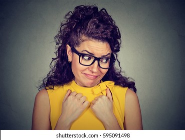 Lack Of Confidence. Shy Woman Feels Awkward Isolated On Grey Wall Background. Human Emotion Body Language Life Perception