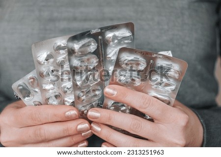  Lack of drugs in the pharmacy. Empty blisters from medicines in female hands close-up.Lack of medicines. Empty packaging set from pills in hands.medicine is over