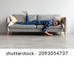 Lack of Energy Concept. Full Body Length Of Exhausted Sleepless Young Man Lying On The Couch With Face Down, Tired In The End Of Hard Working Day, Fatigued Middle Eastern Male Resting At Home