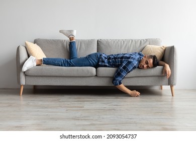 Lack of Energy Concept. Full Body Length Of Exhausted Sleepless Young Man Lying On The Couch With Face Down, Tired In The End Of Hard Working Day, Fatigued Middle Eastern Male Resting At Home - Powered by Shutterstock