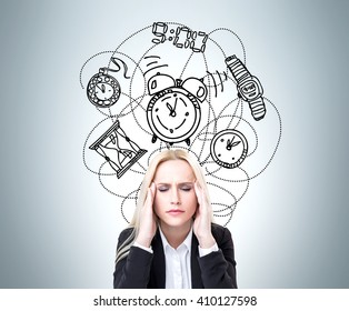 Lack Of Time Concept With Stressed Businesswoman On Grey Background