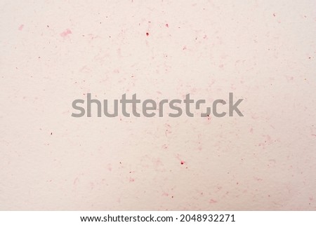 Laconic beige background with red flecks, cream background.