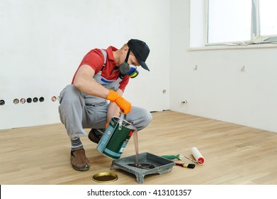 Lacquering Wood Floors. Worker Pours Floor Lacquer In The Tray.