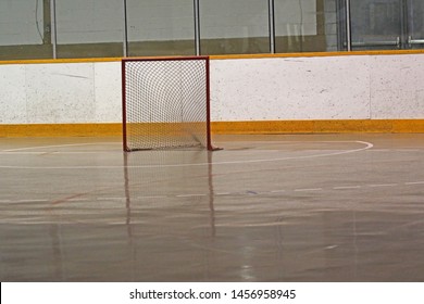 A Lacrosse Net Sitting In An Empty Box.