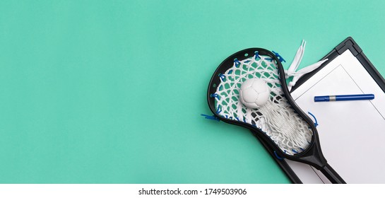 Lacrosse Stick, Ball And Tactical Board With Marker On Green Background. Sport Coach Concept