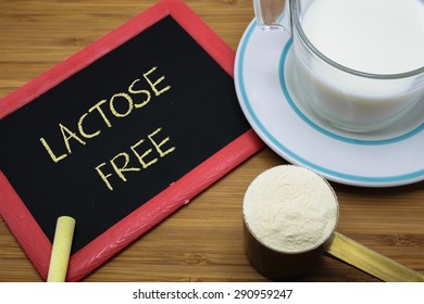 Lactose free word on chalk board with a cup of milk and  milk powder