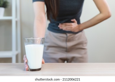 lactose intolerance concept. Woman having a stomachache because drink milk.