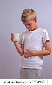 Lactose Intolerance. Dairy Intolerant Child With Stomach Pain Holding A Glass Of Milk.