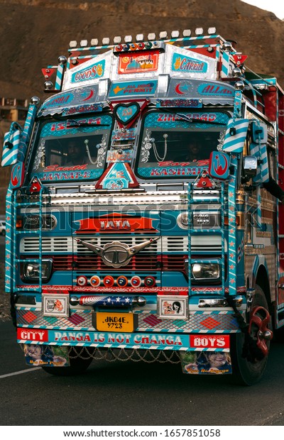 LADAKH, KASHMIR, INDIA – JUNE 22, 2019:\
Colorful big blue and red and white truck driving on road of\
Kashmir in India near\
mountains