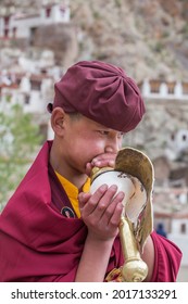 Ladakh, Northern India - june 26, 2015 : Young tibetan buddhist monk blowing the trumpet during Hemis Festival at Ladakh, North India