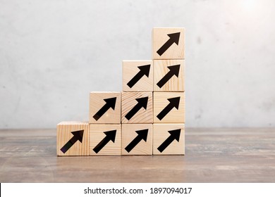 Ladder career path for business growth success process concept. Hand arranging wood block stacking as step stair with arrow up