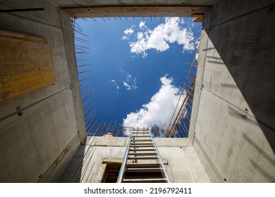 Ladder In The Elevator Shaft Of A Monolithic Concrete Apartment Building Under Construction