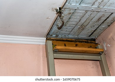 Ladder Leading To Closed Door Latch To Attic With Wooden Ceiling In Retro Vintage Dacha Cottage Home In Country Countryside Closeup