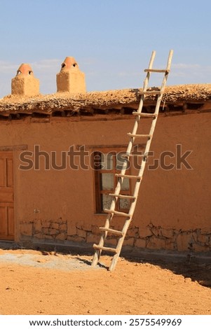 ladder leaning on the wall of the earthen house