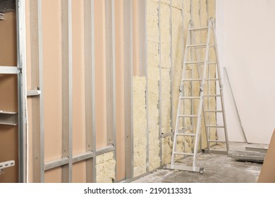 Ladder Near Wall With Metal Studs And Insulation Material Indoors