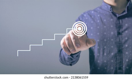 the ladder rises to the goal. man tapping on the screen - Shutterstock ID 2138061559