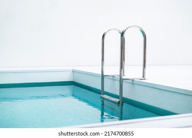 Ladder stainless handrails for descent into swimming pool. Swimming pool with handrail . Ladder of a swimming pool. Horizontal shot. - Shutterstock ID 2174700855