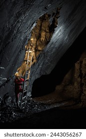 A ladder in a vertical shaft in a large slate mine system.