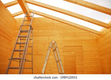 Ladders and empty door frames in a partially constructed wood (fir) block house, a pre-cut wooden house which is assembled on-site in Italy