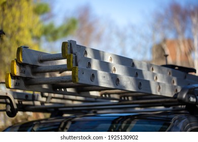 Ladders On The Roof Rack Of A Builders Van