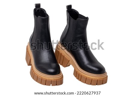 Ladies Chelsea boots. Close-up of a pair womens black leather chelsea boots with high heels isolated on a white background. Clipping path. Fashion advertisment shoes.
