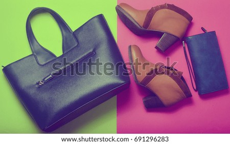 Ladies Fashion accessories. A modern leather bag, low-boots, a purse. Trend neon colors.