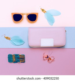 Ladies Fashion Accessories. Pink Clutch, Sunglasses and Jewelry. Pastel Colors Trend