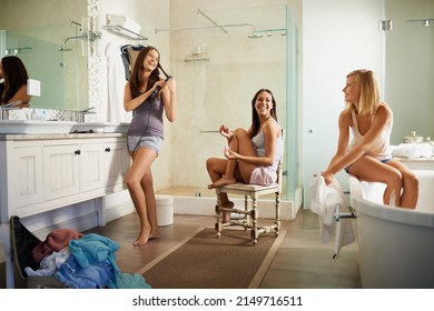 The Ladies Are Getting Ready. Shot Of Three Beautiful Young Women Getting Ready In The Bathroom.