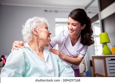 Ladies having a friendly conversation, diligent nurse and senior resident patient, doctor patient concept