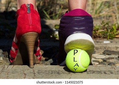 Ladies Legs, One Foot In The Court Shoe And The Other Foot In A Sports Shoe And A Tennis Ball With The Inscription Play.