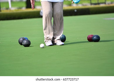 Ladies Playing Lawn Bowls. Soft Focus On The Blurred Background.