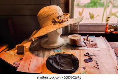 Ladies Straw Hat And Sewing Memorabilia On Table In Workshop Of Historical Pioneering Family Home - Grain Enhancement To Replicate The Photography Era