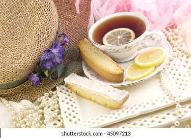 A Ladies Tea Party With A Cup Of Tea Served On Fine China, Fresh Lemon Slices, And Lemon Biscotti On The Side, Perfect For Mother's Day