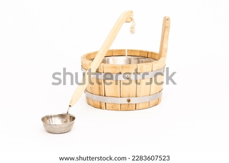 ladle for water for a bath with a cap on a long handle on a white background