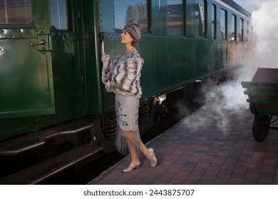 Lady in 1920s flapper dress costume waiting for the steam train on a train platform - Powered by Shutterstock