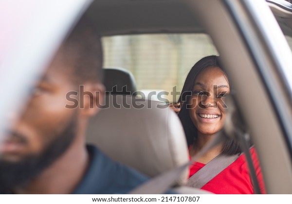 lady in the back\
of a car making a phone\
call
