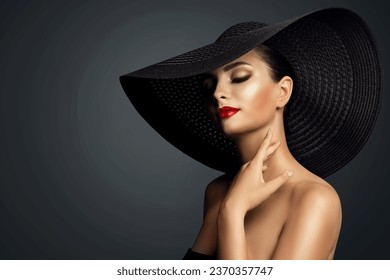 Lady in Black Hat with Red Lipstick Make up. Elegant Woman with Face Makeup and Nails Manicure over Dark Gray. Beautiful Model touching Neck Skin and dreaming - Powered by Shutterstock