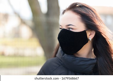 Lady with a black respirator mask.