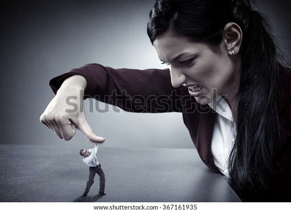 Lady\
boss crushing an employee under her thumb like a\
bug