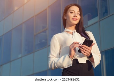 Lady Business Manager Stands Near Office And Chats With Friend. Young Woman In Businesswear Smiles Looking At Camera, Sinlight