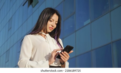 Lady Business Manager Stands Near Office And Chats With Friend. Young Woman In Businesswear Smiles Looking At Camera