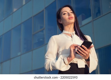 Lady Business Manager Stands Near Office And Chats With Friend. Young Woman In Businesswear Smiles Looking At Camera, Copyspace